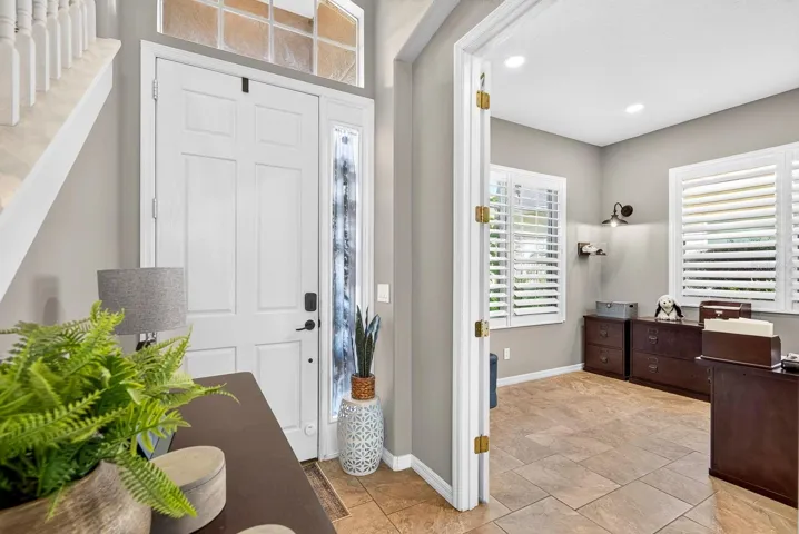 Entry looking at front door and office with french doors