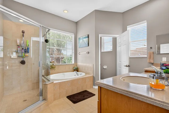 Master bath area featuring walk in shower and tub