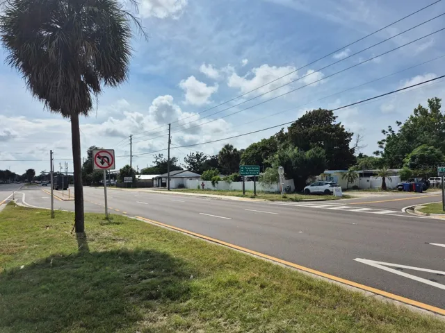 Facing North West from median of SR 54, looking at property.