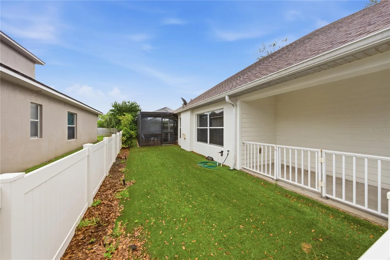 Putting green or dog run along side of home.