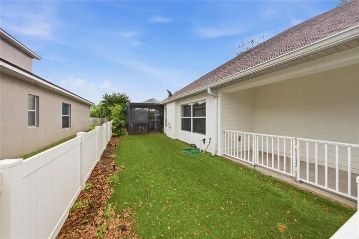 Putting green or dog run along side of home.
