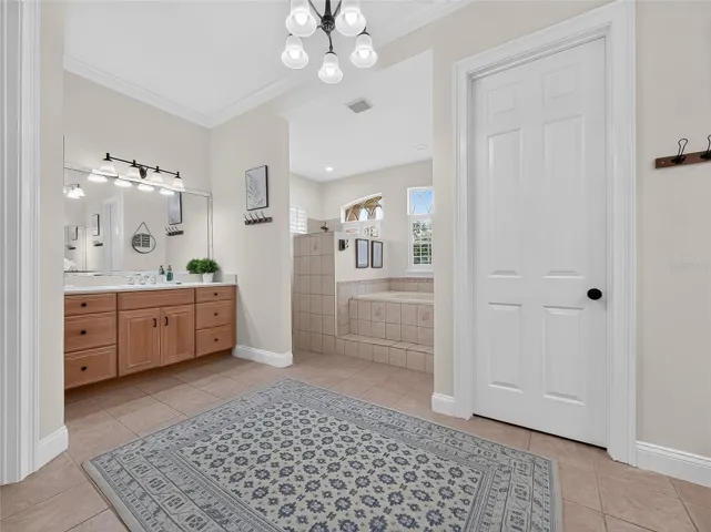 Primary bathroom with walk in shower, dual vanities, soaker tub and walk in shower