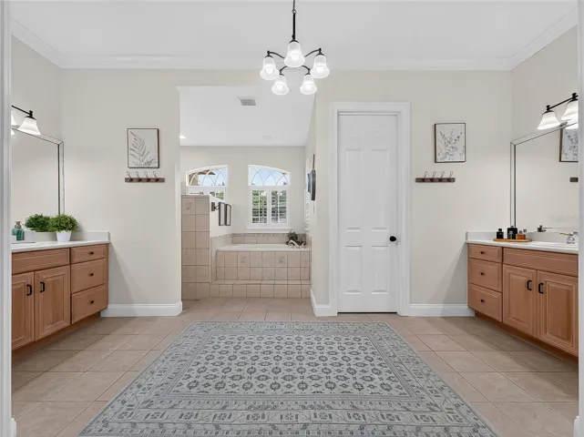 Primary bathroom with walk in shower, dual vanities, soaker tub and walk in shower
