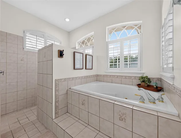 Primary bathroom with walk in shower, dual vanities, soaker tub and walk in shower