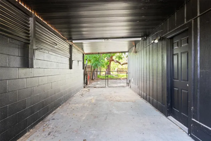 Covered Carport with door to converted Garage