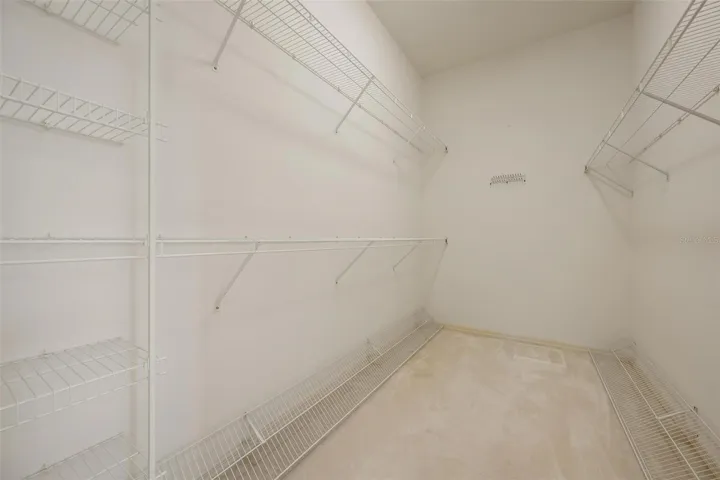 Primary bedroom walk-in closet