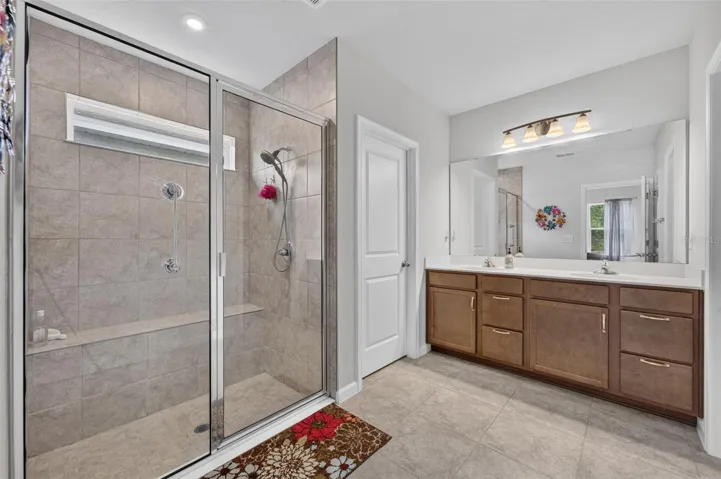 Primary bathroom with spacious shower and double vanity sinks
