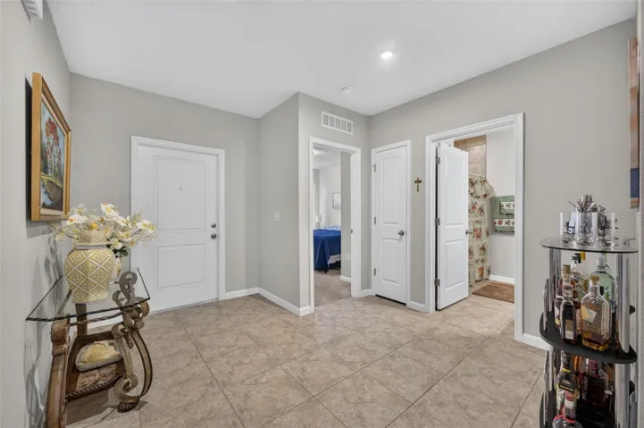 Spacious front entrance with guest bedroom and bath in background