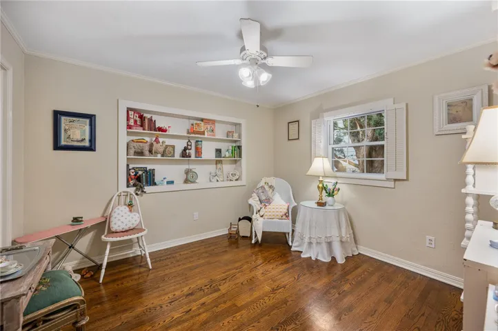 Bedroom #3 with wood floors, ceiling fan and shutters