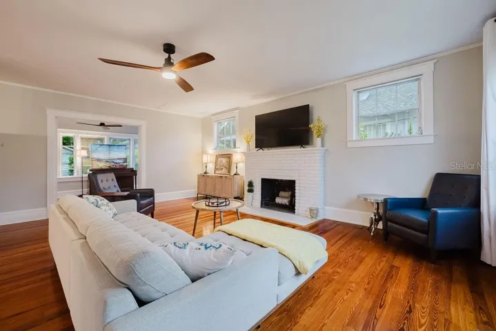 Living room opening to sun room.
