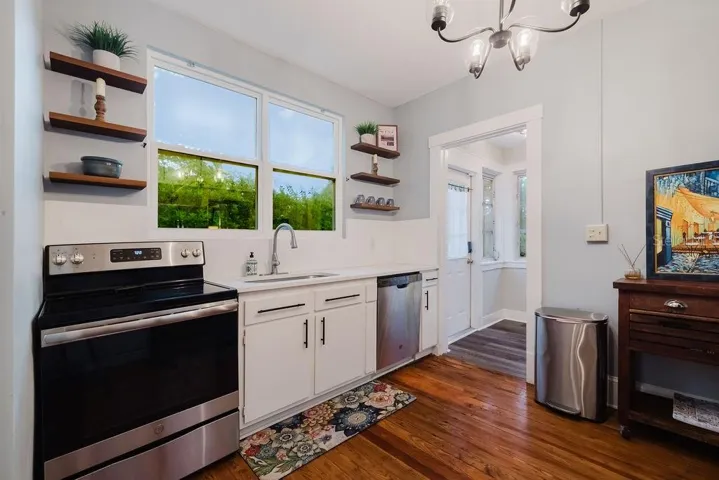 Kitchen with stainless steel appliance and door to back yard.