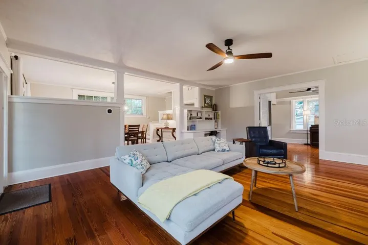 Living room connected to formal dining and sunroom/office.