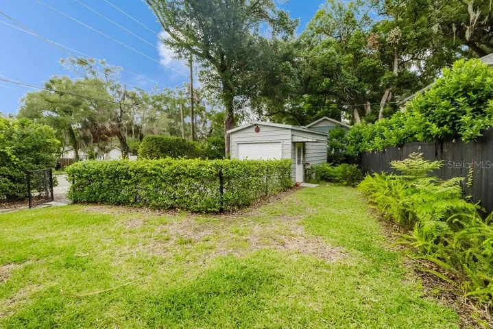 Fully fenced backyard with patio area and one-car storage workshop.