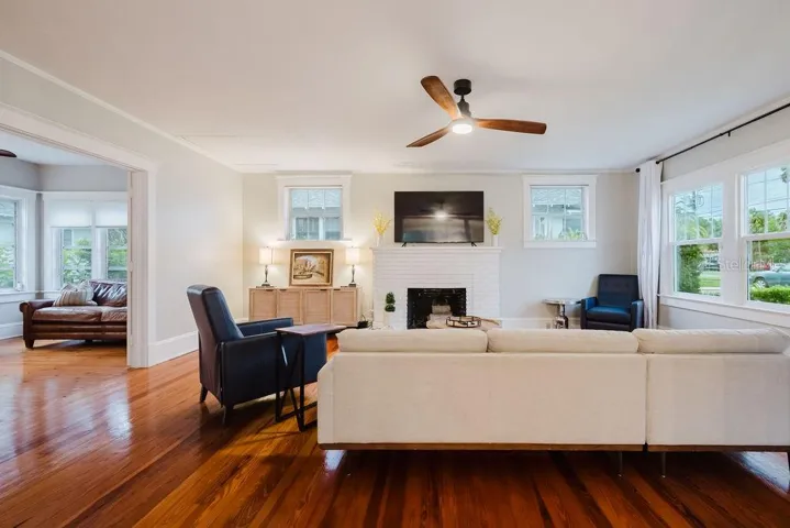 Living room with brick fireplace and new windows. Sunroom right off living room can double as home office with double doors for privacy.