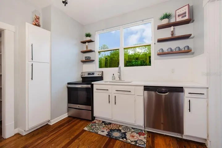 Kitchen with pantry, stainless steel appliances, and all wood cabinets.