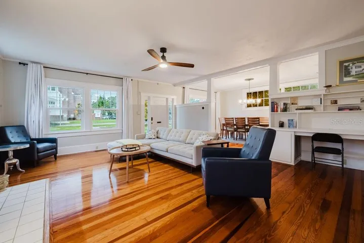 Living room with view of front door and dining room. Original built-in desk circa 1920.