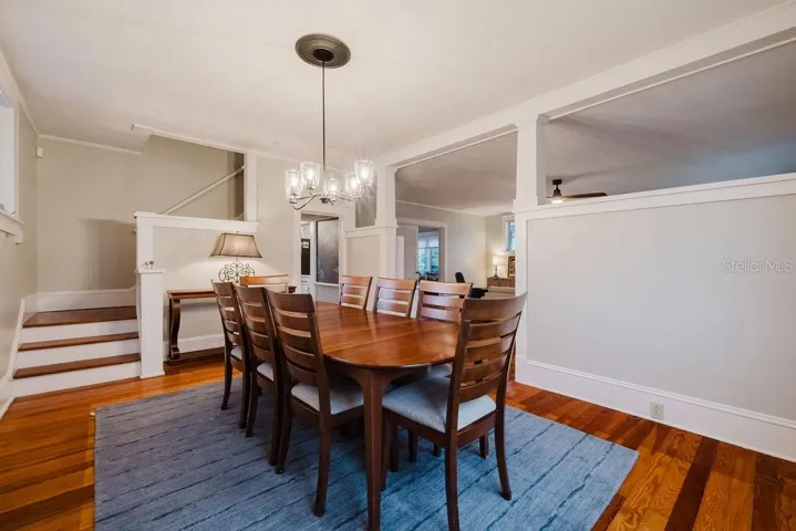 Dining room opening to living room and stairwell landing.