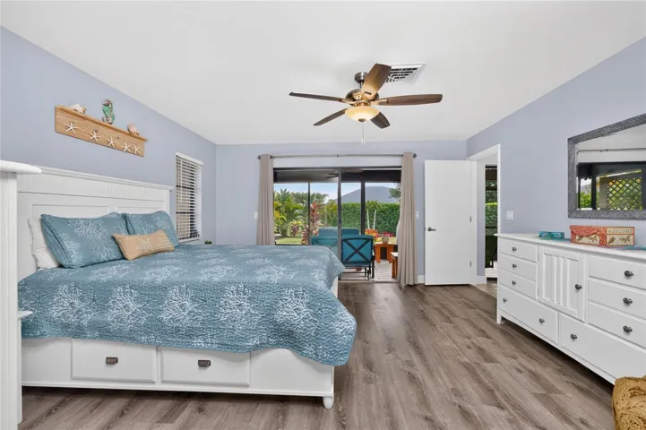 A view of the primary bedroom looking out toward the lanai.