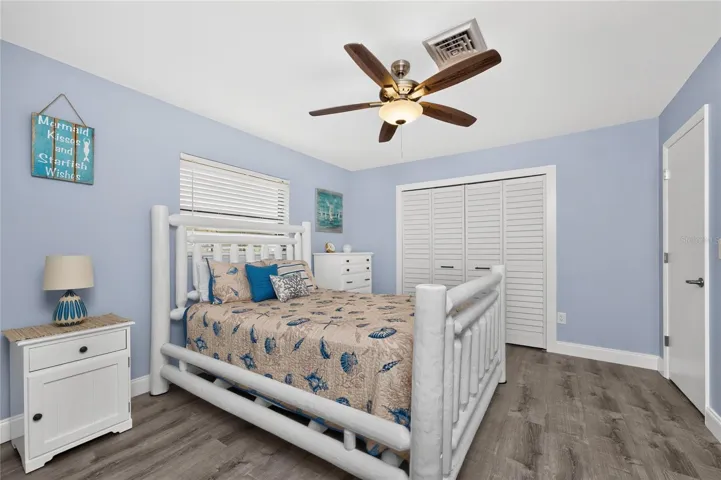The guest bedroom has a wall closet and ceiling fan.