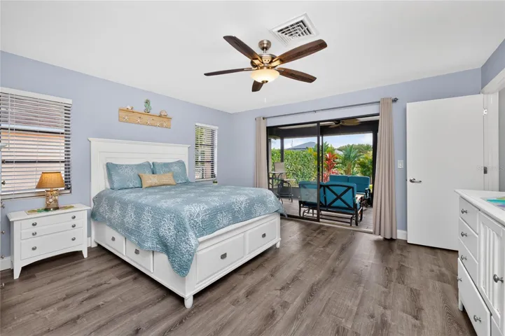 Primary bedroom has sliding glass doors opening on to the lanai.
