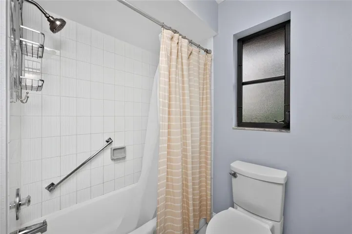 The guest bathroom has a combination tub/shower.