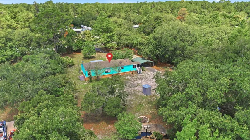 HOME IN CENTER AND TREES ALL AROUND