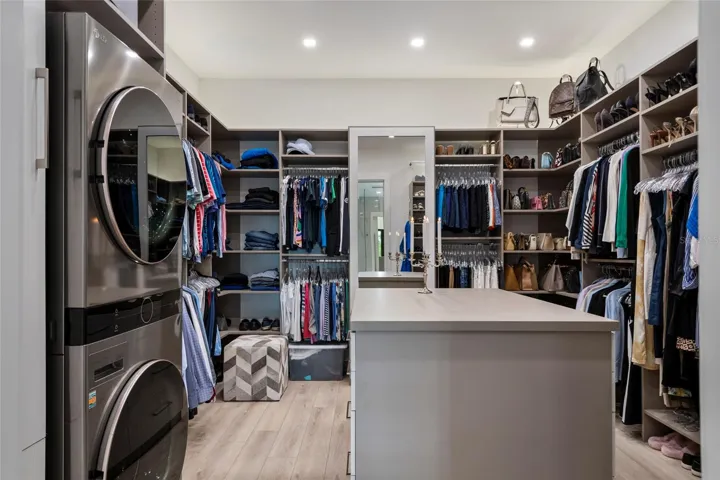 PRIMARY WALK IN CLOSET WITH SECONDARY WASHER/DRYER
