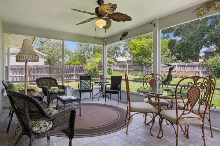 Paver patio area off the screened porch with space for grilling and outdoor seating.