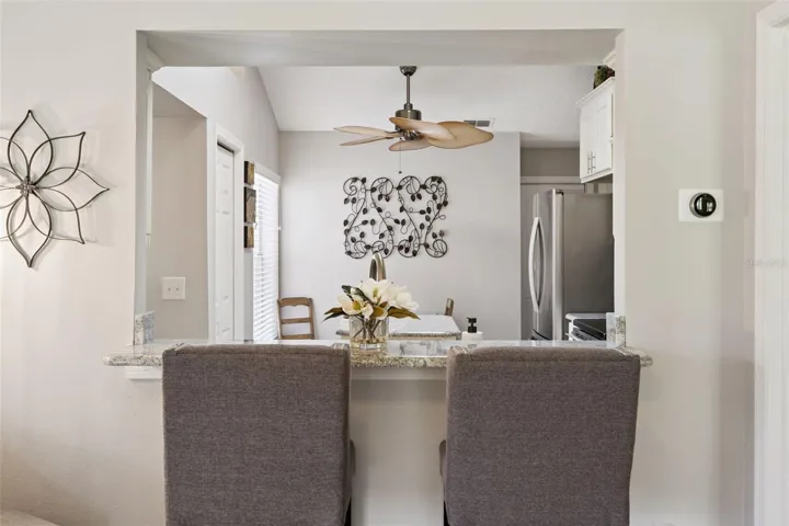 Convenient breakfast bar seating connecting the living room to the kitchen, ideal for casual meals and entertaining.