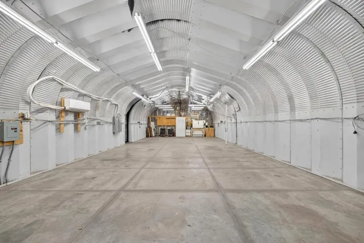 *Virtually Staged Empty* Larger garage with higher ceiling, A/C, water, electric and workshop in the back.