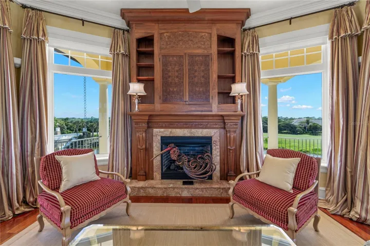 A perfect pairing of artistry and comfort, the custom built-ins and fireplace invite quiet reflection while showcasing the beauty beyond the windows.