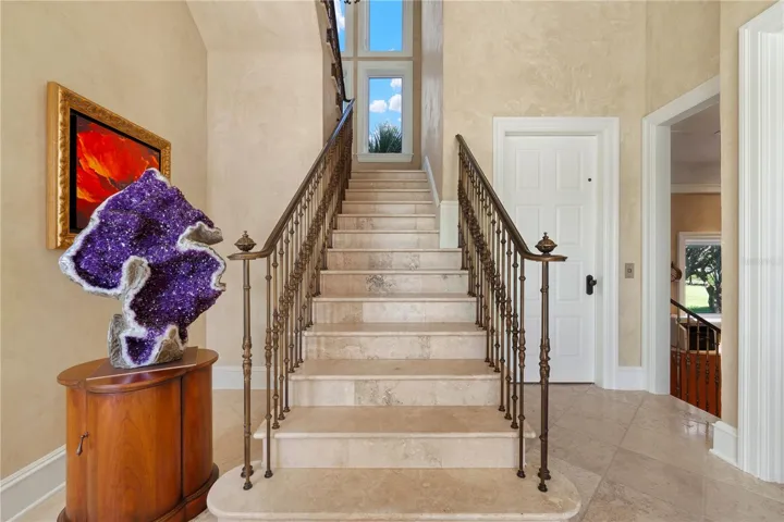 The staircase is accented by custom solid bronze railings, selected not only for their beauty but also for their durability and ability to withstand the coastal salt-air environment.