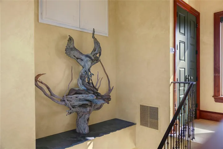 Standing watch in the third-story stairwell, this custom Paul Baliker osprey sculpture is more than art—it's a statement piece that captures the spirit of coastal living.