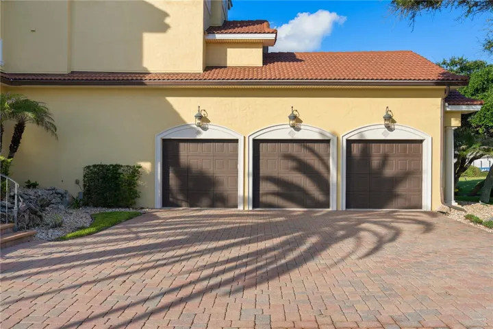 A three-car garage provide plenty of room for vehicles, golf carts, and guests, blending everyday convenience with the scale expected of a luxury estate.
