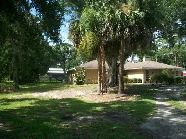 Standing in front yard looking at the other side of the home, looking into side yard