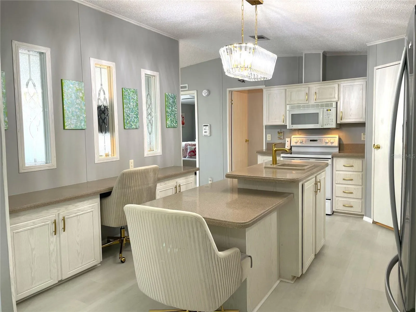 Windows in center wall allow natural light into the Kitchen