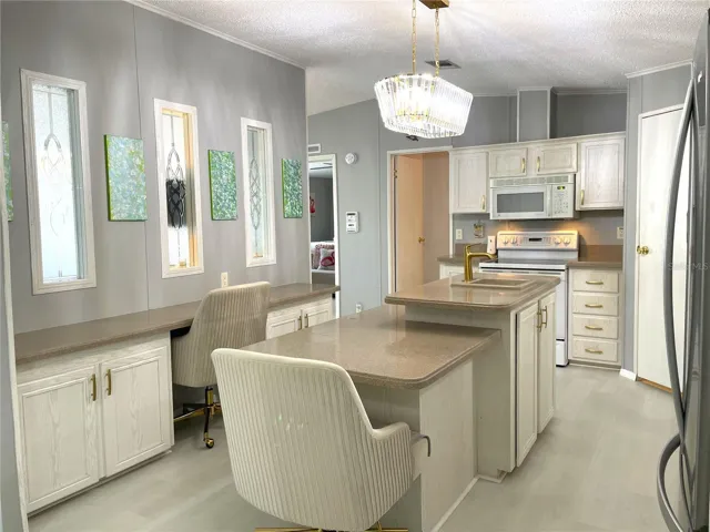 Windows in center wall allow natural light into the Kitchen
