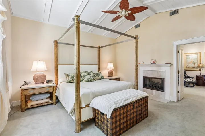 Primary bedroom w/ double sided gas fireplace