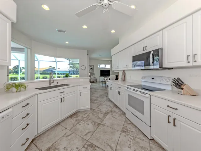 This very bright kitchen features a double closet pantry, over looks the dinette, sparkling pool, and opens to the large family room!