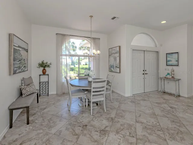 Double entry doors lead open to a foyer that overlooks the formal living and dining room with beautiful views to the lanai and pool.