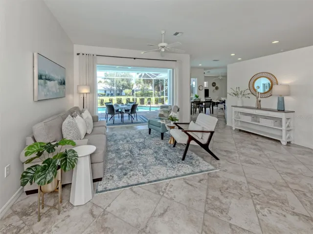 This formal living room features large pocketing sliding glass doors that opens the the spacious lanai