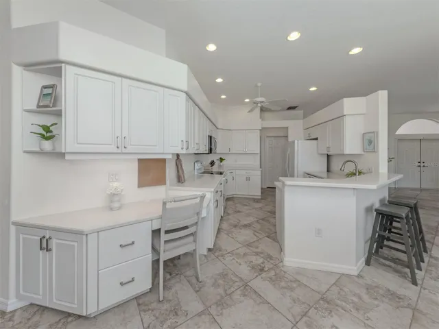 This larger kitchen is large and includes a breakfast bar