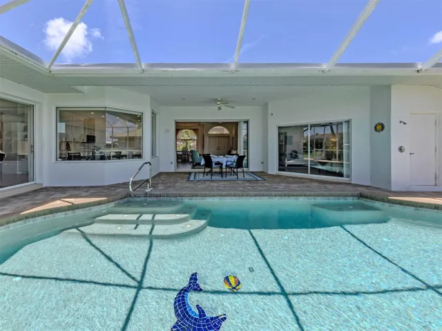 This beautiful pool area includes a small side paver patio outside of the lanai for grilling, storage closet, outdoor shower, and beautiful views!