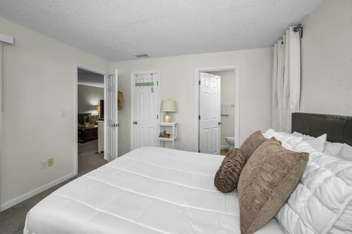 Doorway to living area, walk-in closet, and primary bath