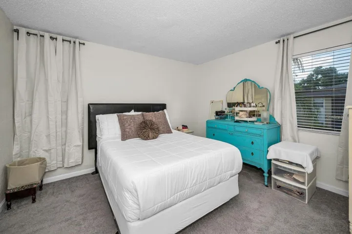 Primary bedroom offers windows to view side and rear of property.