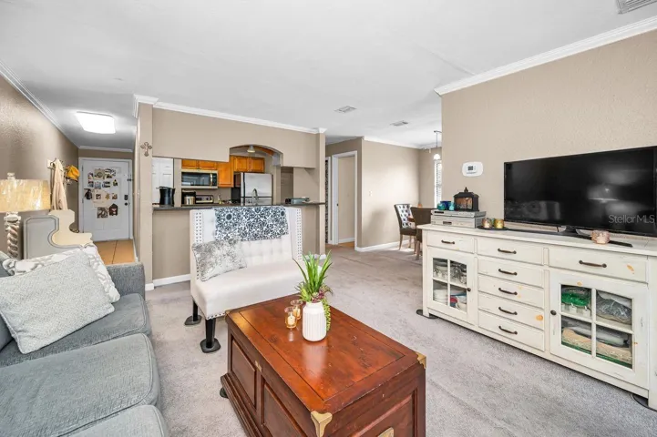 Home entry to left, dining area to right, additional bedrooms down hallway to right of kitchen. Primary suite to right of photo.