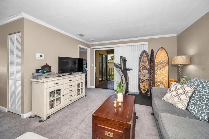 Looking towards primary suite, both rooms have entrances to screened patio.