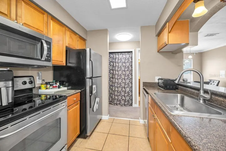 Kitchens offers passthrough to living area with view of the outdoors