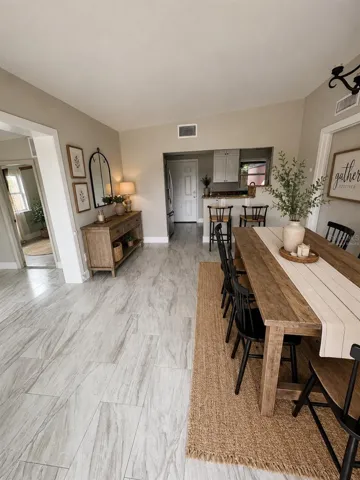Virtually staged entrance with dining room