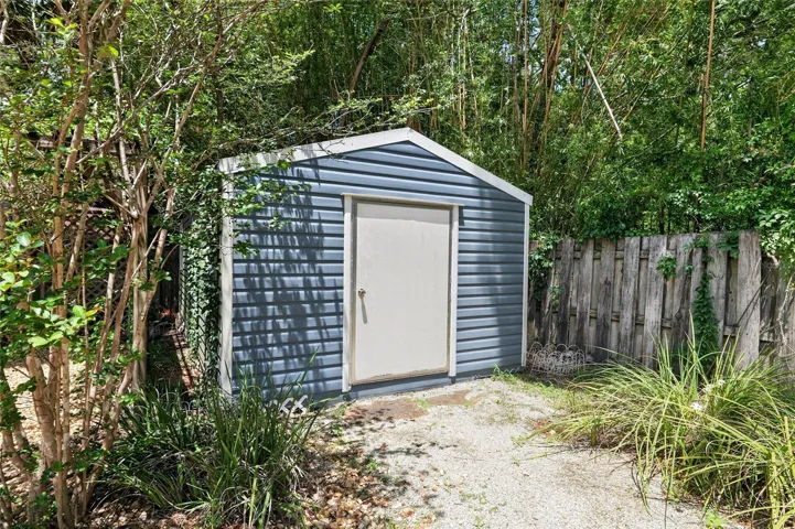 HUGE 12 X 25 STORAGE SHED TUCKED INTO SIDE OF PROPERTY